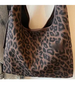 Detailed view of leopard print tote bag with soft fabric and leather trim