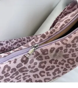 Detail of pink leopard tote bag showing the smooth silver metal zipper and fabric texture