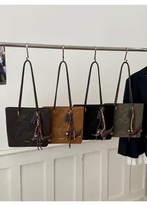 Detail view of four large tote bags in grey, brown, black and green with dog charms