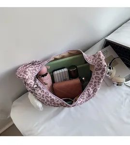 Macro view of leopard print hobo bag interior showing spacious capacity for daily essentials