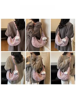 Pink leopard print crescent shoulder bag shown on model from multiple angles with charm