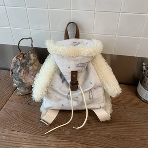 Detail of creative humanoid backpack featuring grey canvas and plush faux shearling textures