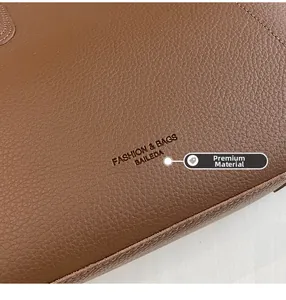 Close-up of premium brown litchi grain leather texture and embossed logo on tote bag