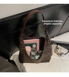 Top view of large leopard print tote bag showing spacious interior with tablet and water bottle