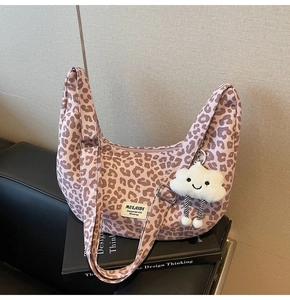 Macro detail of leopard print hobo bag with a plush cloud charm and MULAIDI label