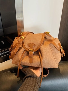 Vintage brown woven bucket bag with leather trim and drawstring closure for women