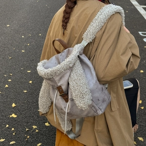 Detail of rabbit ear backpack with plush trim and leather straps in autumn outdoor setting