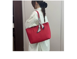 Detail of red leather tote bag with floral scarf and Fashion & Bags text on model