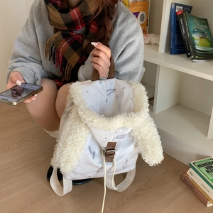 Detail of bunny ear backpack with marble pattern and soft faux fur trim decoration