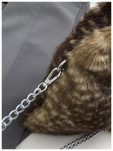 Close-up of leopard print faux fur bag with silver metal chain and lobster clasp hook