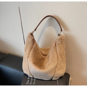 Detail of plush faux mink fur shoulder bag with leather handle and gold hardware