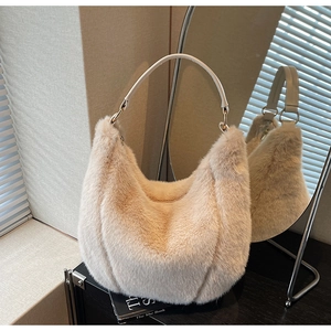 Detailed view of cream plush hobo bag with vertical ribbing and golden metal ring hardware