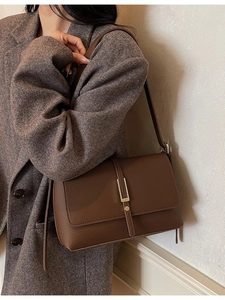 Vintage dark brown pebble leather shoulder bag with gold buckle on model