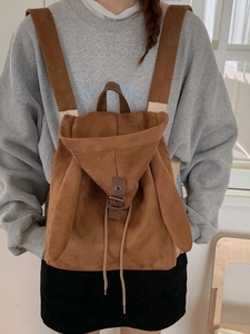 Brown faux suede backpack with cute rabbit ears and leather buckle on model