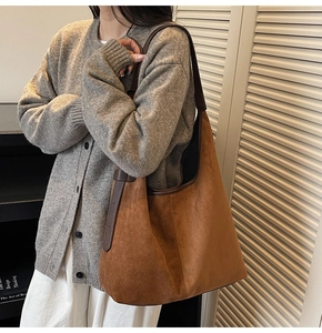 Close-up of retro brown frosted suede tote bag featuring adjustable leather shoulder strap