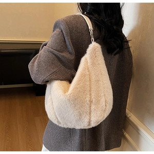 Detail of soft cream plush shoulder bag with smooth leather strap and silver hardware