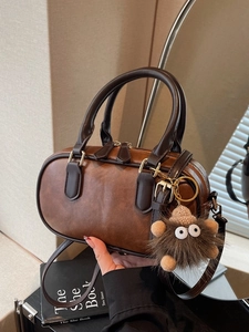 Vintage brown retro cylindrical shoulder bag in PU leather with fuzzy monster charm