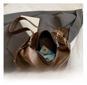 Detail view of the large brown hobo bag interior showing spacious capacity and smooth zipper
