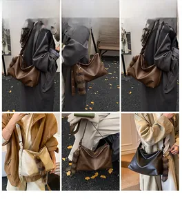 Detail view of large retro hobo bags in coffee, beige, and black with plush tail pendant