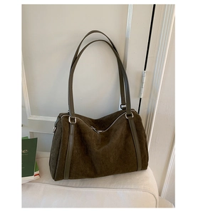 Detail view of the textured dark brown matte suede surface on this large shoulder bag