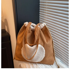 Detail of vintage brown suede tote bag with white sherpa trim and drawstring feature