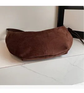 Close-up of the vintage dark brown suede texture and premium soft material of this crossbody bag