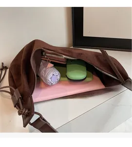 Interior view of large capacity brown suede shoulder bag showing spacious storage space