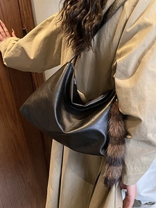 Retro black glossy leather Hobo bag with large capacity and decorative raccoon tail charm