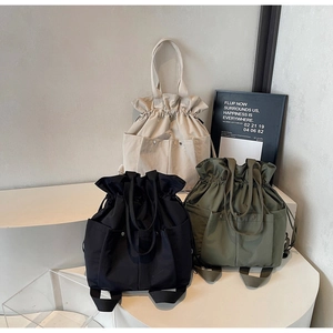 Three-color multi-functional canvas bucket bags displayed in ivory, black, and olive green