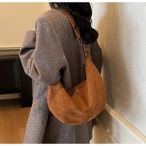Close-up of brown suede hobo bag with vintage texture and detailed stitching