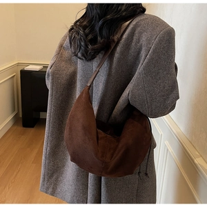 Detail view of brown suede hobo bag texture and side drawstring for commuting style