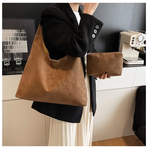 Brown matte leather tote bag with matching pouch shown on a model for a chic daily look
