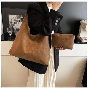 Brown frosted leather hobo tote bag and small zipper pouch shown on a model