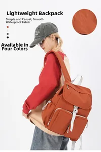 Detail of waterproof smooth fabric on a lightweight orange backpack with large capacity