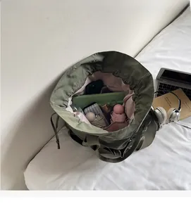 Macro interior view of army green bucket bag showing large capacity and multi-pockets