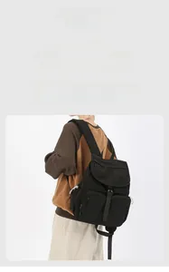 Detail view of durable black nylon travel backpack with multi-pocket functional design