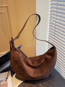Chic dark brown suede crescent shoulder bag with minimalist knot detail for women