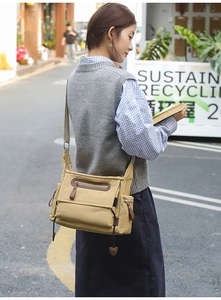 Khaki messenger bag shown on shoulder with durable nylon fabric and multiple pockets