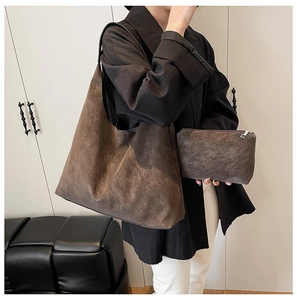 Detail of vintage matte brown tote bag with matching zippered pouch and soft texture
