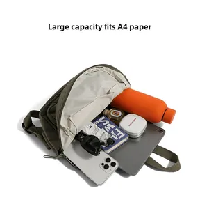 Detail shot of green nylon backpack showing large capacity for tablet and essentials