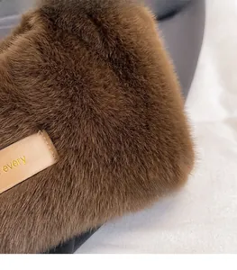 Detailed macro view of soft brown plush material and leather label with Every Day text