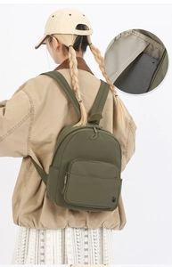 Detailed interior view of military green nylon backpack showing spacious tablet storage