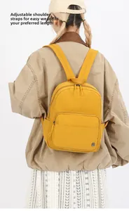 Detail of adjustable shoulder straps on a water-resistant bright yellow nylon backpack