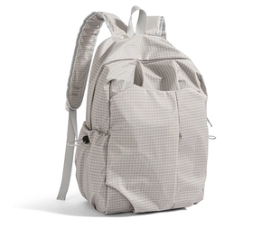 Side view of light grey backpack featuring fine grid texture and adjustable side drawstrings