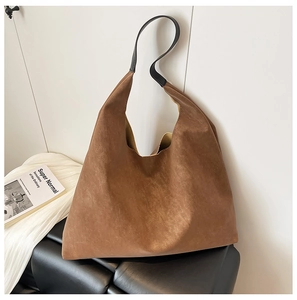 Brown suede tote bag shown in a lifestyle setting with a minimalist hobo silhouette