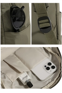 Detail view of military green nylon backpack showing side pocket and interior compartments