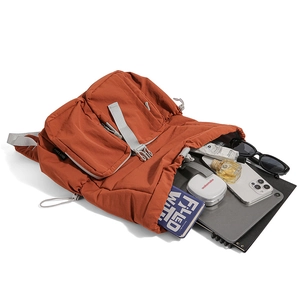 Top view of orange nylon backpack showing large storage capacity for tablets and books