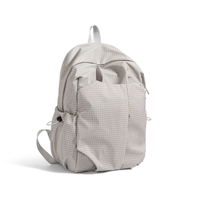 Close-up of lightweight light grey plaid backpack with drawstring side pockets and zip closure