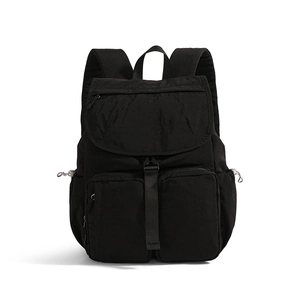 Front view of black nylon backpack featuring large flap and double square front pockets