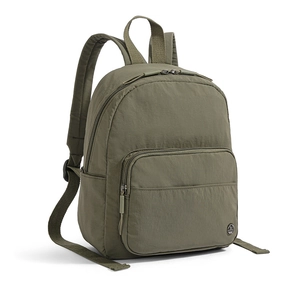 Detail view of olive green nylon backpack showing front zip pocket and circular metal logo